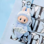 Sweetened by the bubble magic of the carousel, the limited-edition Fish Tail Lion Vinyl Doll is the star of the new LABUBU travel: a little carnival in plush form