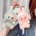 Beloved Labubu now twinkles down the street in a pint-sized macaron dream, and she’s slipped into a mystery blind box that’s ready to pop surprise into every pocket